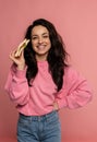 Smiling happy young dark-haired woman showing a nourishing sandwich in her hand during the studio photo shoot. Healthy Royalty Free Stock Photo