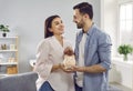 Smiling, happy young family together put coins in piggy bank to save money. Royalty Free Stock Photo