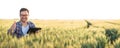 Smiling happy young farmer or agronomist using a tablet in a wheat field. Showing thumbs-up and looking directly at camera