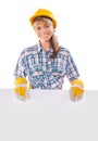 Smiling happy young female construction worker with white placard isolated on white background Royalty Free Stock Photo