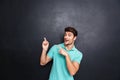 Smiling happy young man pointing fingers away with both hands Royalty Free Stock Photo