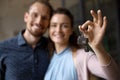 Smiling happy young married couple holding keys from new home Royalty Free Stock Photo