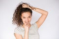 Smiling and happy young woman look at one side with curly hair