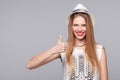 Smiling happy young woman showing thumbs up, isolated on gray Royalty Free Stock Photo