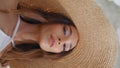 Smiling hat model posing at white houses alley closeup. Posh girl vertical view