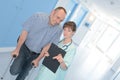 Smiling healthcare worker talking with man with crutches Royalty Free Stock Photo