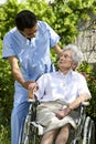 Smiling healthcare worker talking to an handicapped senior Royalty Free Stock Photo