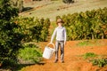 Smiling healthy boy on citrus farm holding bucket