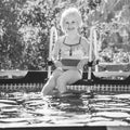 Smiling healthy girl sitting in swimming pool Royalty Free Stock Photo