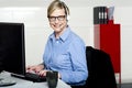 Smiling help desk woman typing on keyboard Royalty Free Stock Photo
