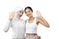 Smiling hijab girl and young girl smiling with waving hands to the camera