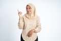 Smiling hijab woman with finger pointing hand gesture