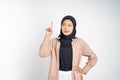 Smiling hijab woman with finger pointing up hand gesture