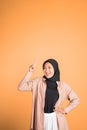 Smiling hijab woman with finger pointing up hand gesture