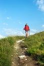 Smiling hiking young woman with backpack