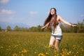 Smiling hippie in summer flowers field Royalty Free Stock Photo