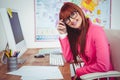 Smiling hipster businesswoman at her desk Royalty Free Stock Photo