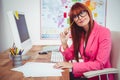 Smiling hipster businesswoman at her desk Royalty Free Stock Photo