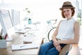 smiling hipster businesswoman sitting at her desk Royalty Free Stock Photo