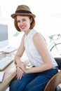 smiling hipster businesswoman sitting at her desk Royalty Free Stock Photo