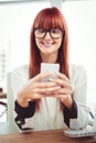 Smiling hipster businesswoman texting on her smartphone Royalty Free Stock Photo