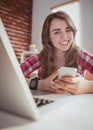 Smiling hipster businesswoman using her phone Royalty Free Stock Photo