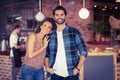 Smiling hipster couple in front of barista