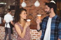 Smiling hipster couple with take-away cups Royalty Free Stock Photo