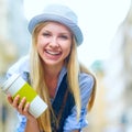 Hipster girl with cup of hot beverage on city street Royalty Free Stock Photo