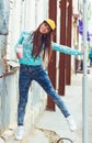 Smiling hipster girl with cup of hot beverage on Royalty Free Stock Photo