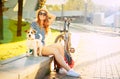 Smiling Hipster Girl with her Dog in Summer City Royalty Free Stock Photo