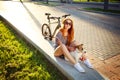 Smiling Hipster Girl with Pet and Bike in Summer Royalty Free Stock Photo