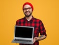 Smiling hipster man with laptop