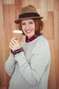 smiling hipster woman in a hat, holding a coffee Royalty Free Stock Photo