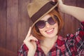 smiling hipster woman wearing a trilby and sunglasses