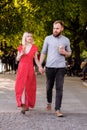 Smiling hipsters couple eating ice cream and having fun in the city. stylish young man with beard and blonde woman in Royalty Free Stock Photo