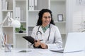 Smiling Hispanic female doctor during a video call consultation