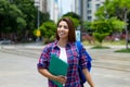 Smiling hispanic female student in city