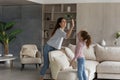 Smiling Hispanic mom and daughter give high five five