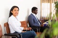 Smiling Hispanic woman waiting for job interview in office Royalty Free Stock Photo