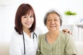 Smiling home caregiver with senior woman