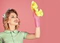 Smiling housewife dressed in retro style. Happy Housekeeper. Retro woman cleaner on pink background. Cleanup, cleaning Royalty Free Stock Photo