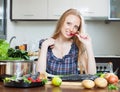 Smiling housewife is thinking how to cook fish Royalty Free Stock Photo