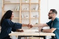 Smiling hr manager shaking African American candidate hand at meeting Royalty Free Stock Photo