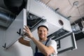 Smiling hvac technician at work. ventilation, heating system maintenance and repair Royalty Free Stock Photo
