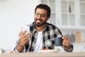 Smiling idian man eating healthy food and using phone Royalty Free Stock Photo