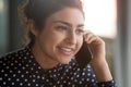 Smiling indian businesswoman secretary manager make business call at work