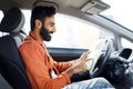 Smiling Indian Driver Man Holding Map Sitting In Modern Automobile