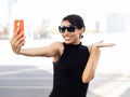 Smiling indian transgender woman taking a selfie during vacation in a city Royalty Free Stock Photo