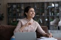 Smiling Indian woman study online on computer at home